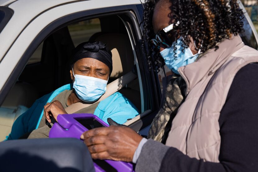 Frenchell White (right) registers Sallie Johnson for a coronavirus vaccination at TR Hoover...