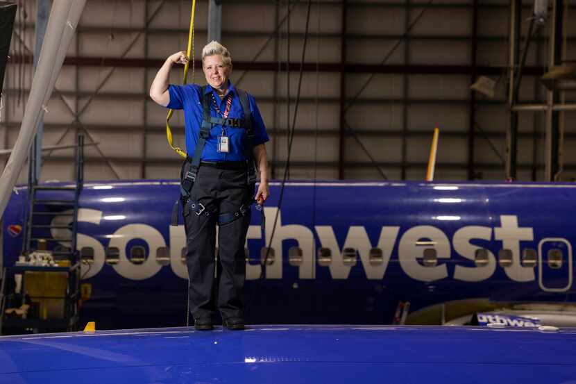 Jennifer Morgan, aircraft maintenance inspector, posed for a photo on top of a plane in...