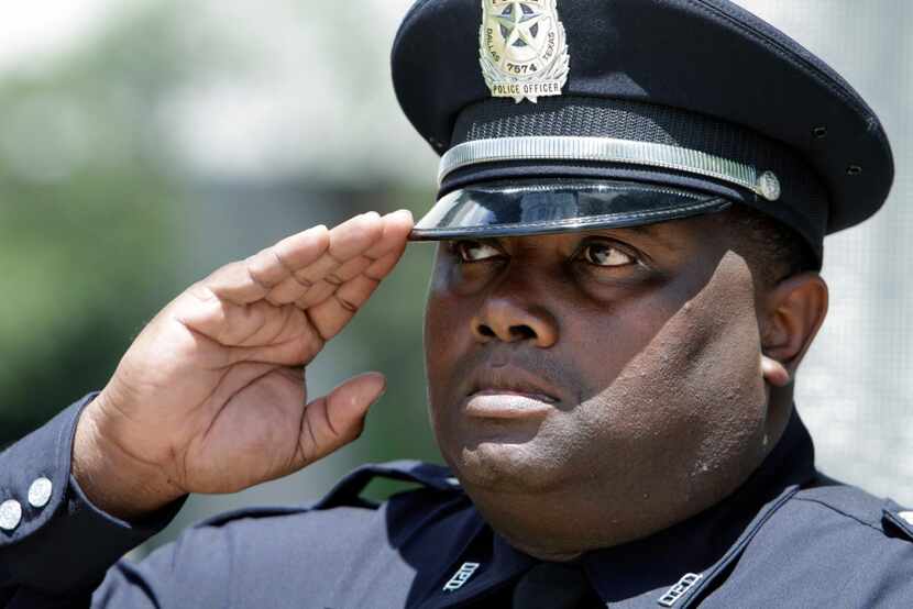 Senior Cpl. D. F. Black salutes during Taps at the annual Dallas Police Memorial Service on...