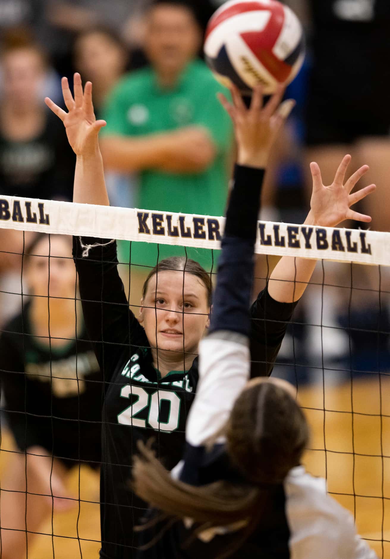 Southlake Carroll’s Kinsley Young (20) goes up to block against Keller during the first set...