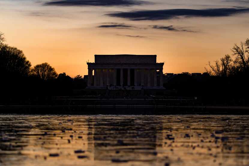 The Lincoln Memorial is seen across the Reflecting Pool at sunset on Saturday, Dec. 26,...