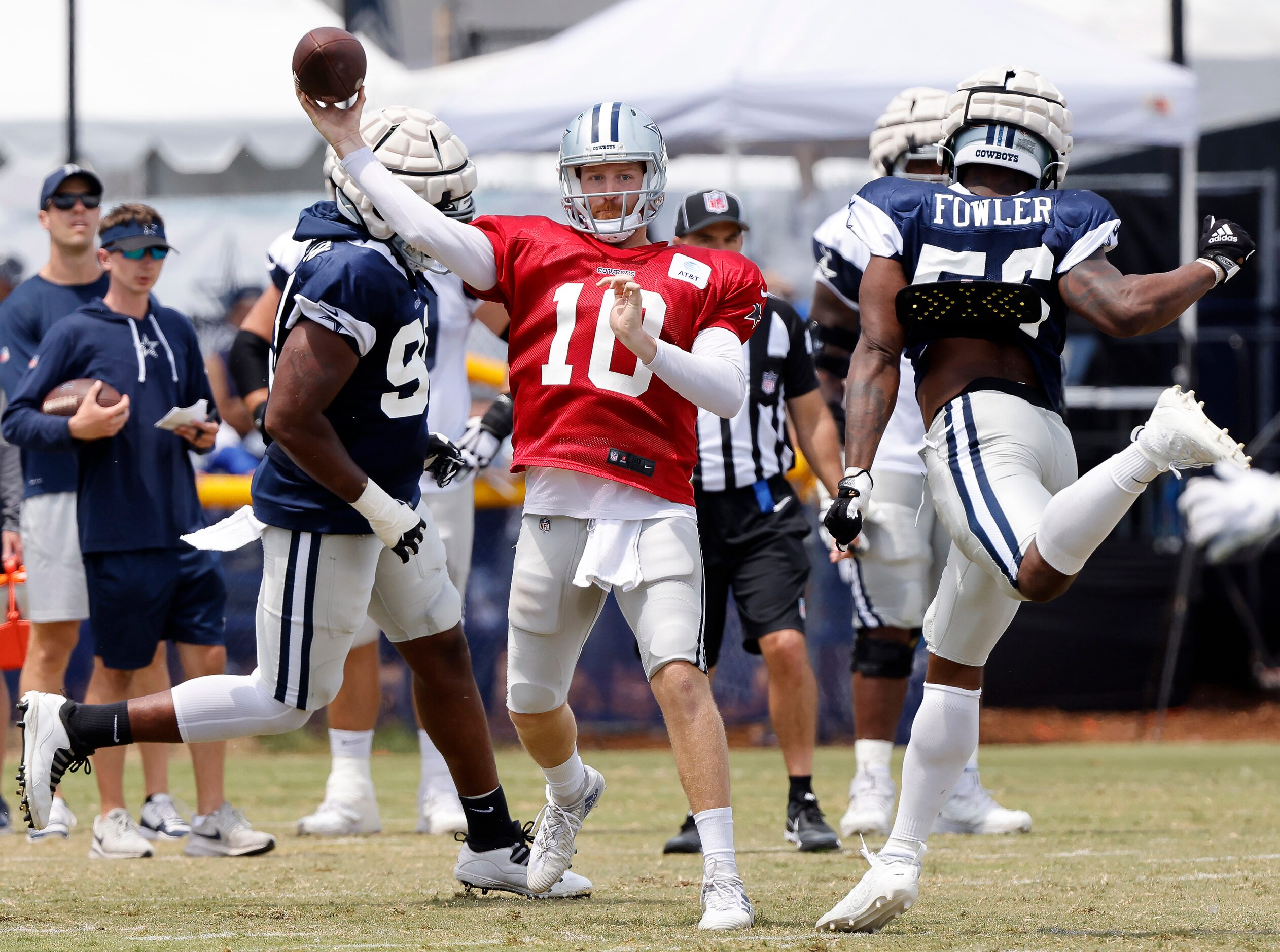 Dallas Cowboys quarterback Cooper Rush (10) releases a pass as defensive ends Chauncey...