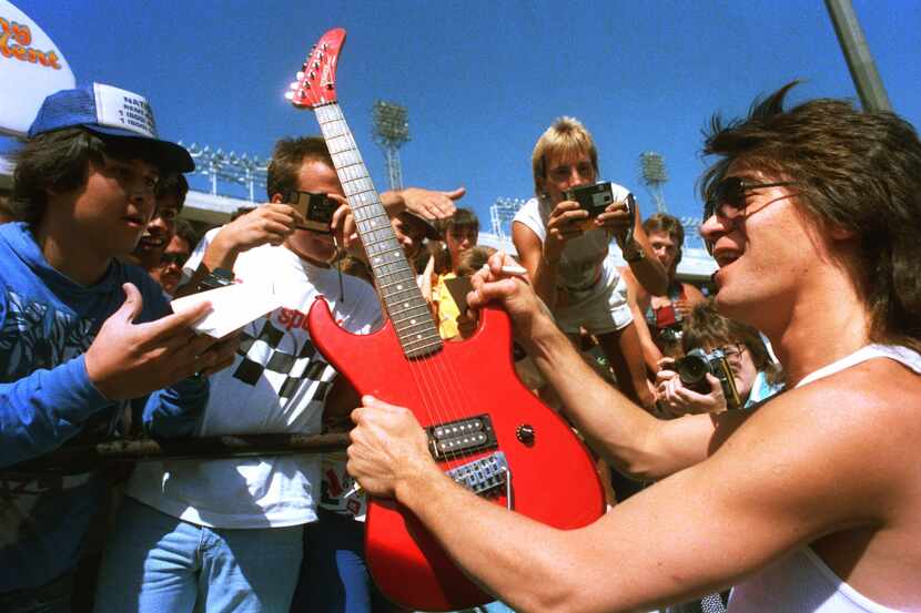 Eddie Van Halen is surrounded by fans at a news conference at the Cotton Bowl on July 17,...