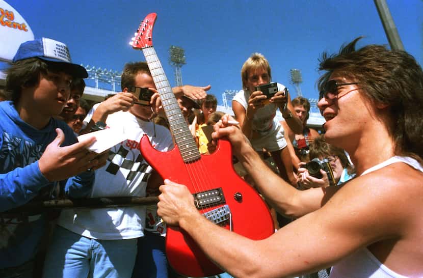Eddie Van Halen is surrounded by fans at a news conference at the Cotton Bowl on July 17,...