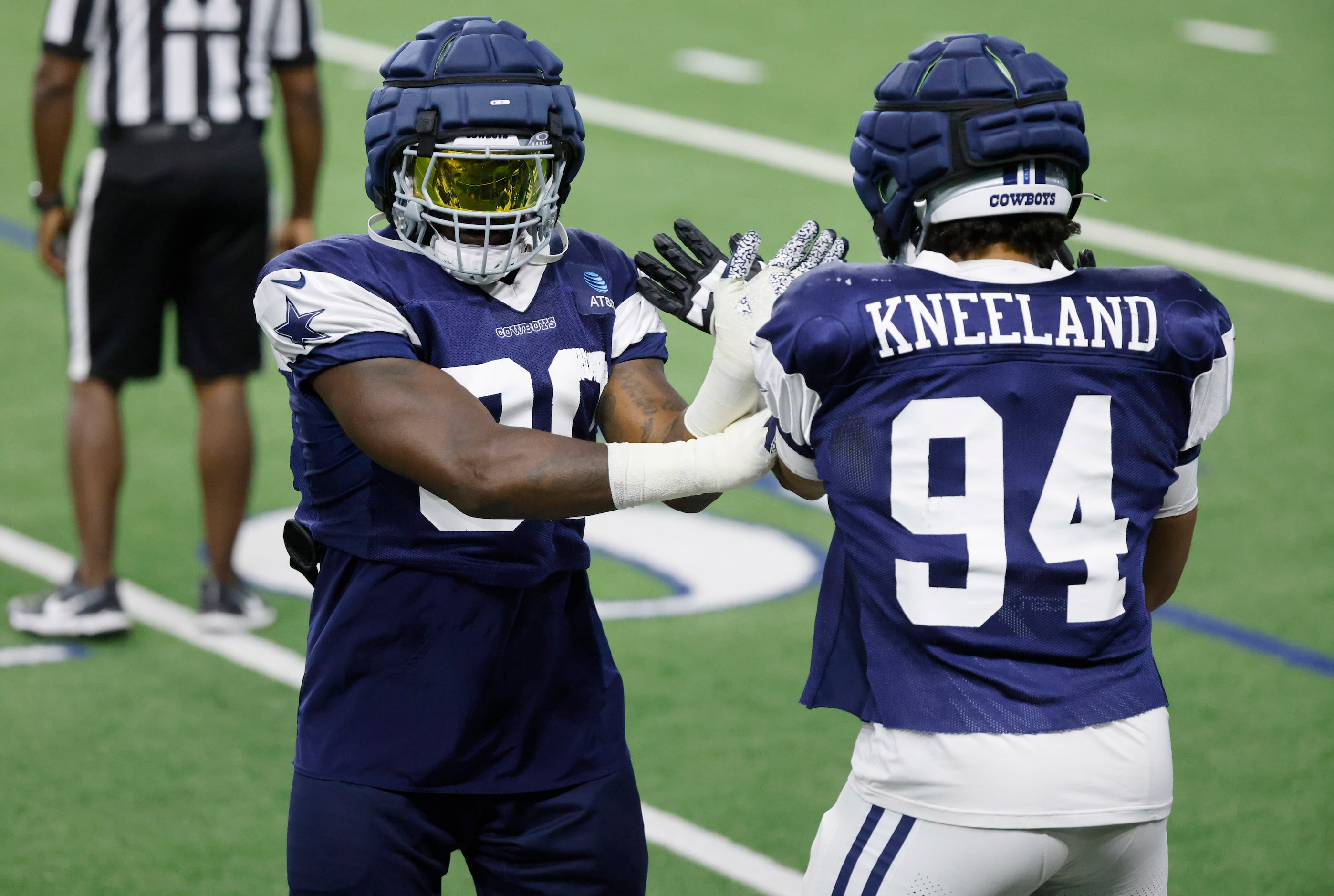 Dallas Cowboys defensive ends DeMarcus Lawrence (90) and Marshawn Kneeland (94) work on...