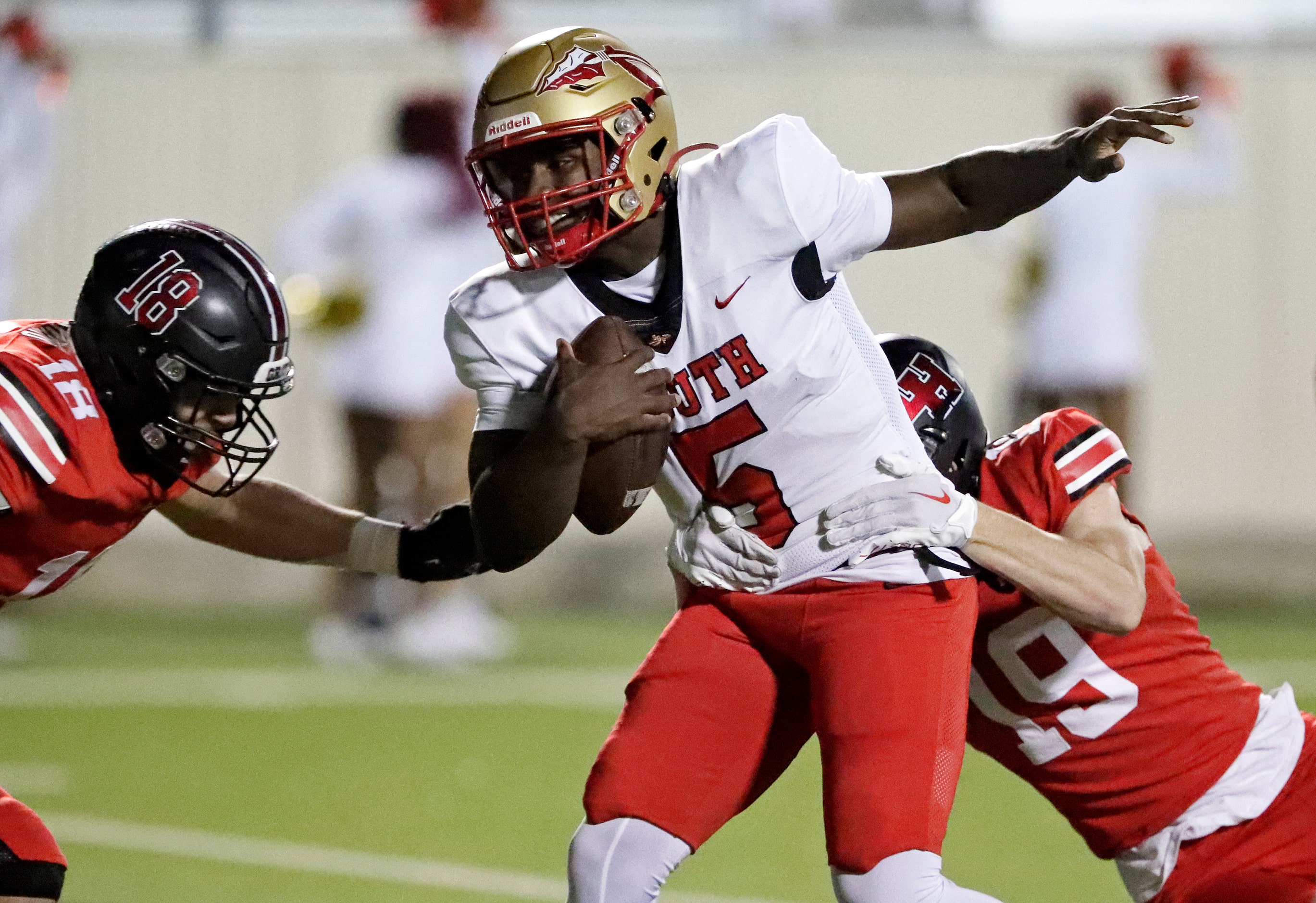 South Grand Prairie High School quarterback Daylon Brooks (5) is brought down by Lake...