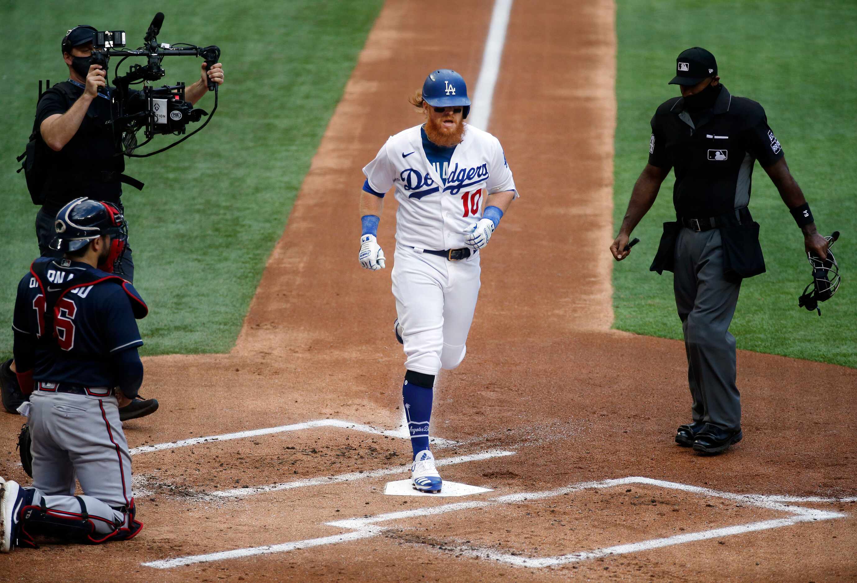 Los Angeles Dodgers Justin Turner (10) crosses home plate after hitting a solo home run...