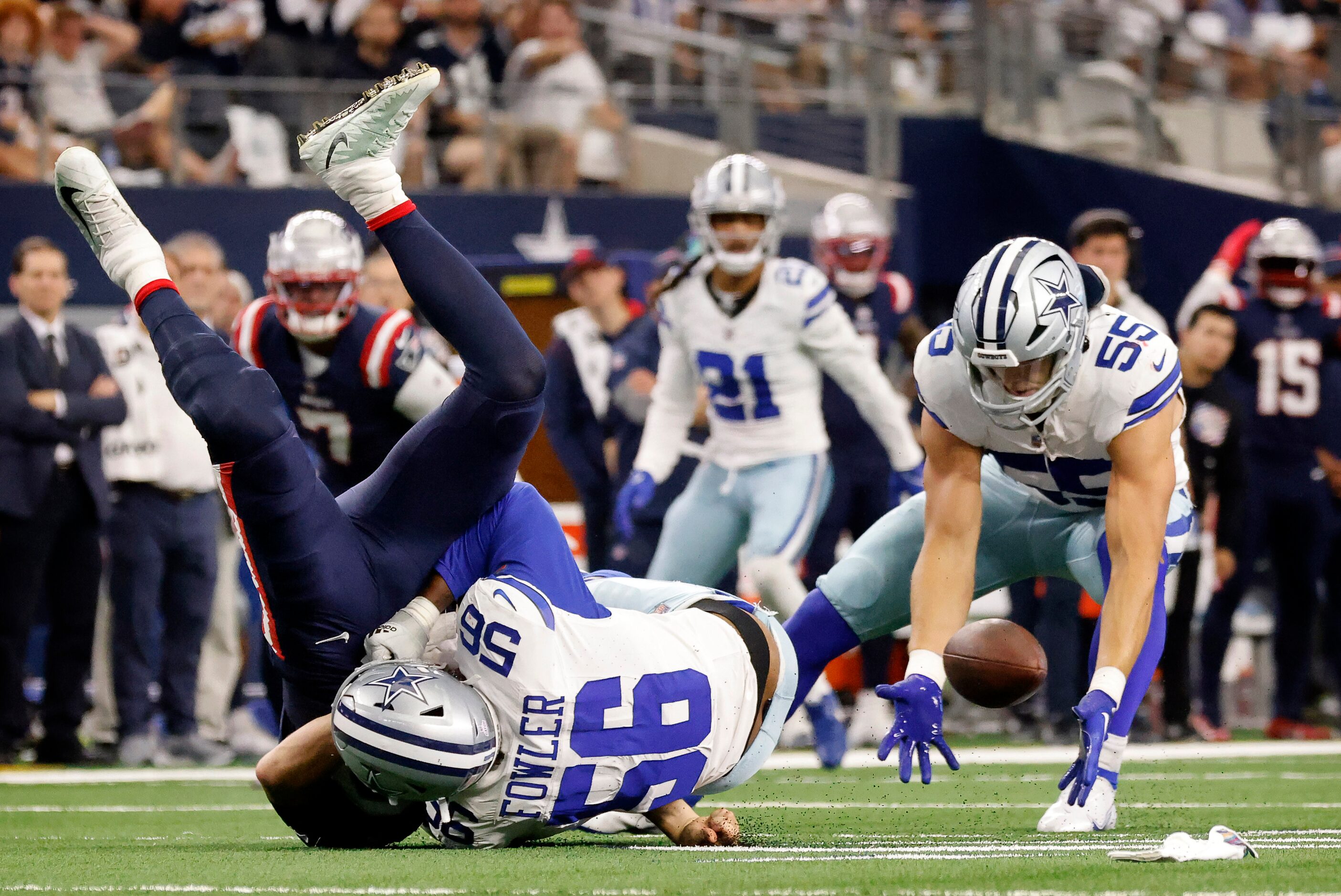 Dallas Cowboys linebacker Leighton Vander Esch (55) scoops up a fumble by New England...