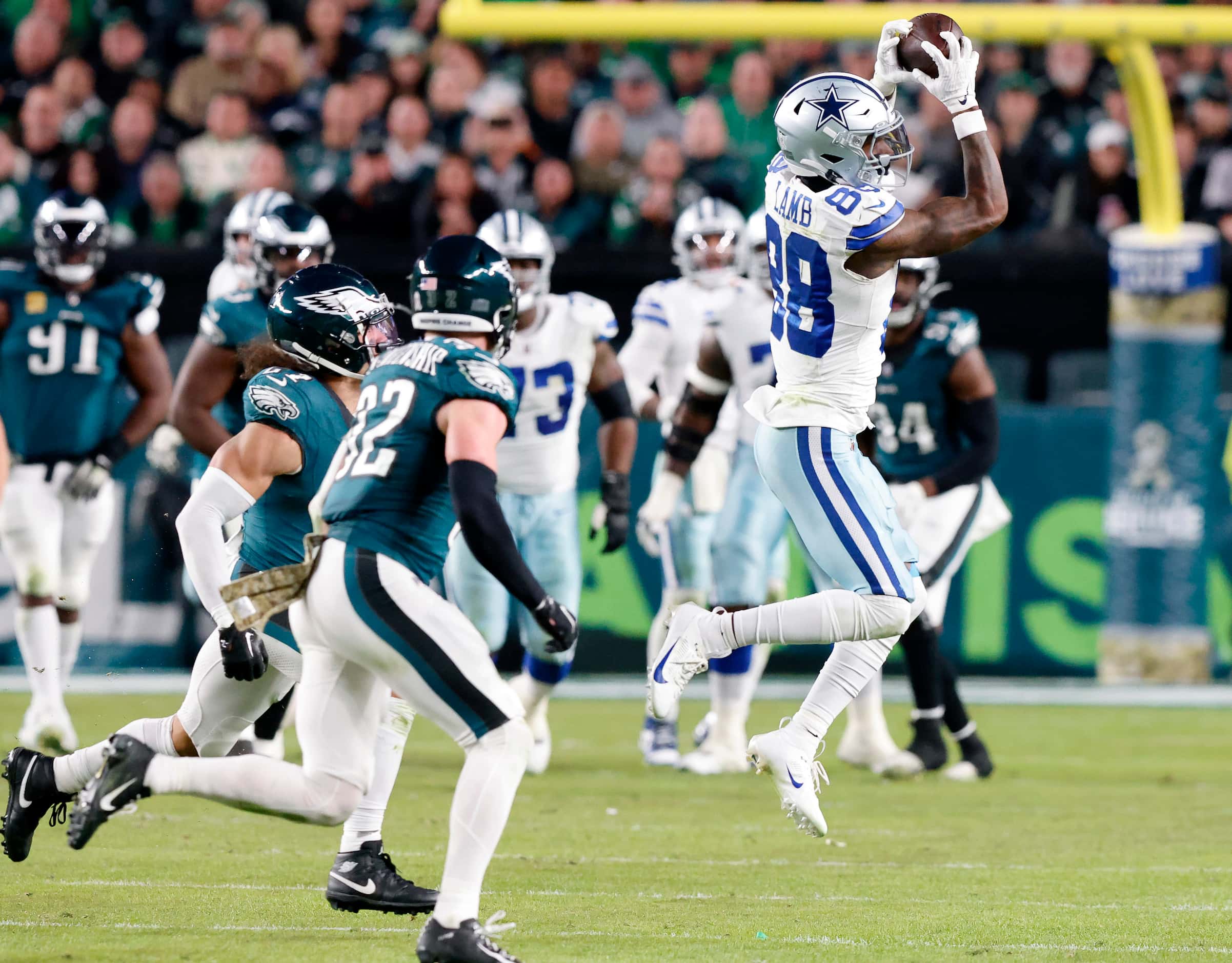 Dallas Cowboys wide receiver CeeDee Lamb (88) makes a leaping catch across the middle of the...