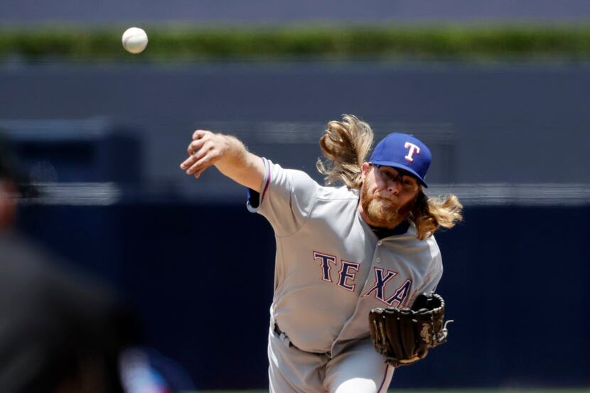 Texas Rangers starting pitcher A.J. Griffin works against a San Diego Padres batter during...