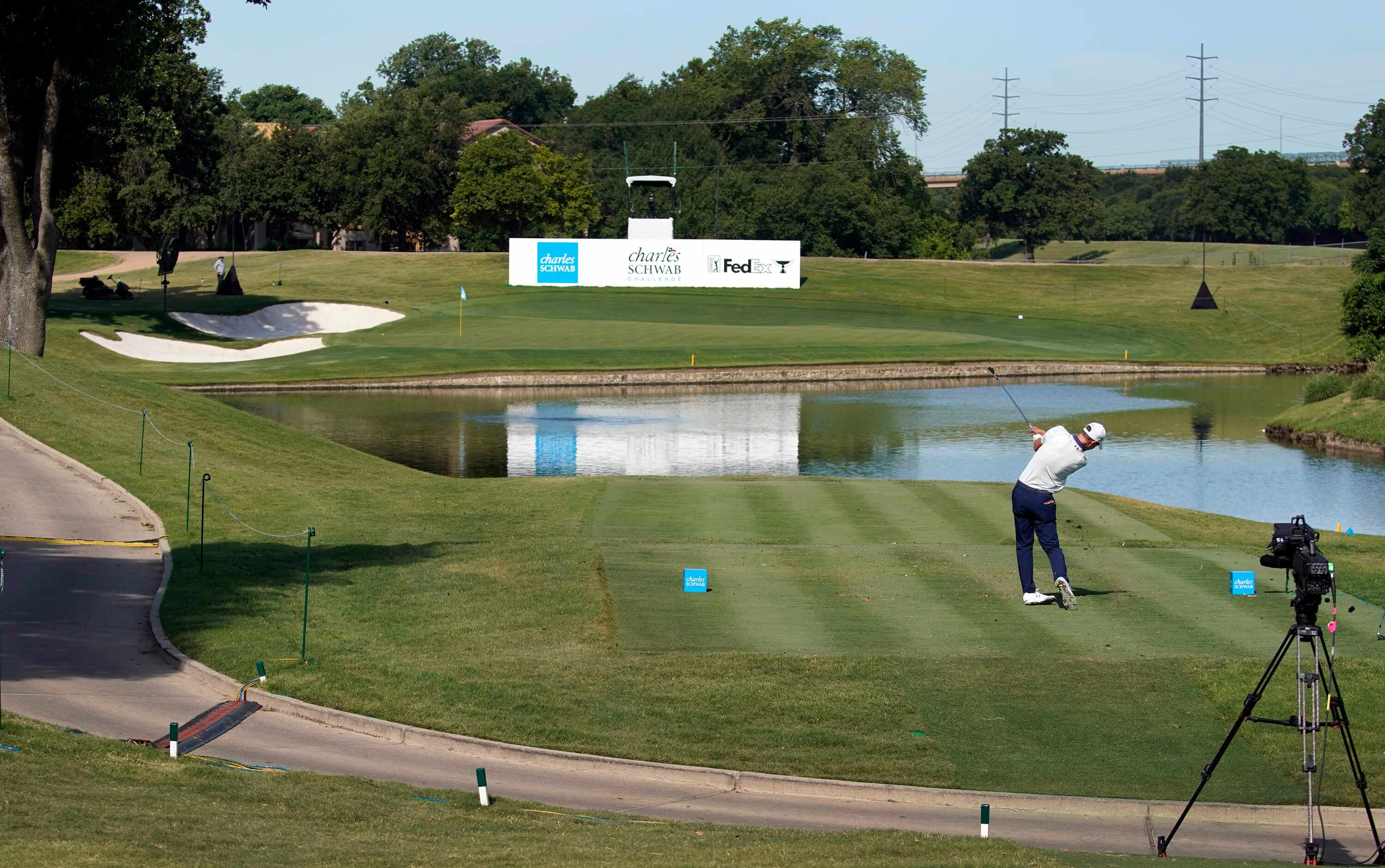 With no fans around the 13th tee box, a PGA Tour golfer follows through on his shot across...