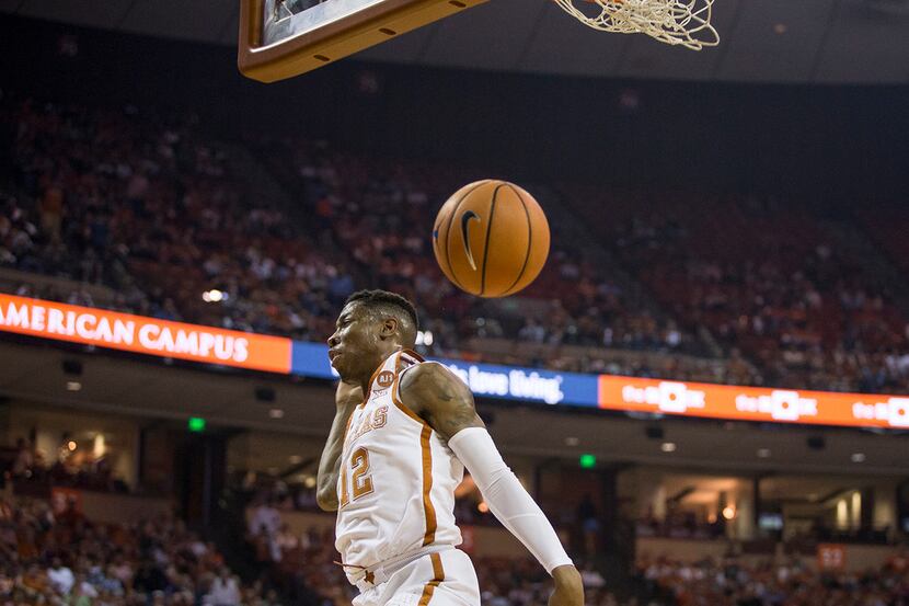 Texas guard Kerwin Roach II (12) dunks the ball during an NCAA college basketball game...