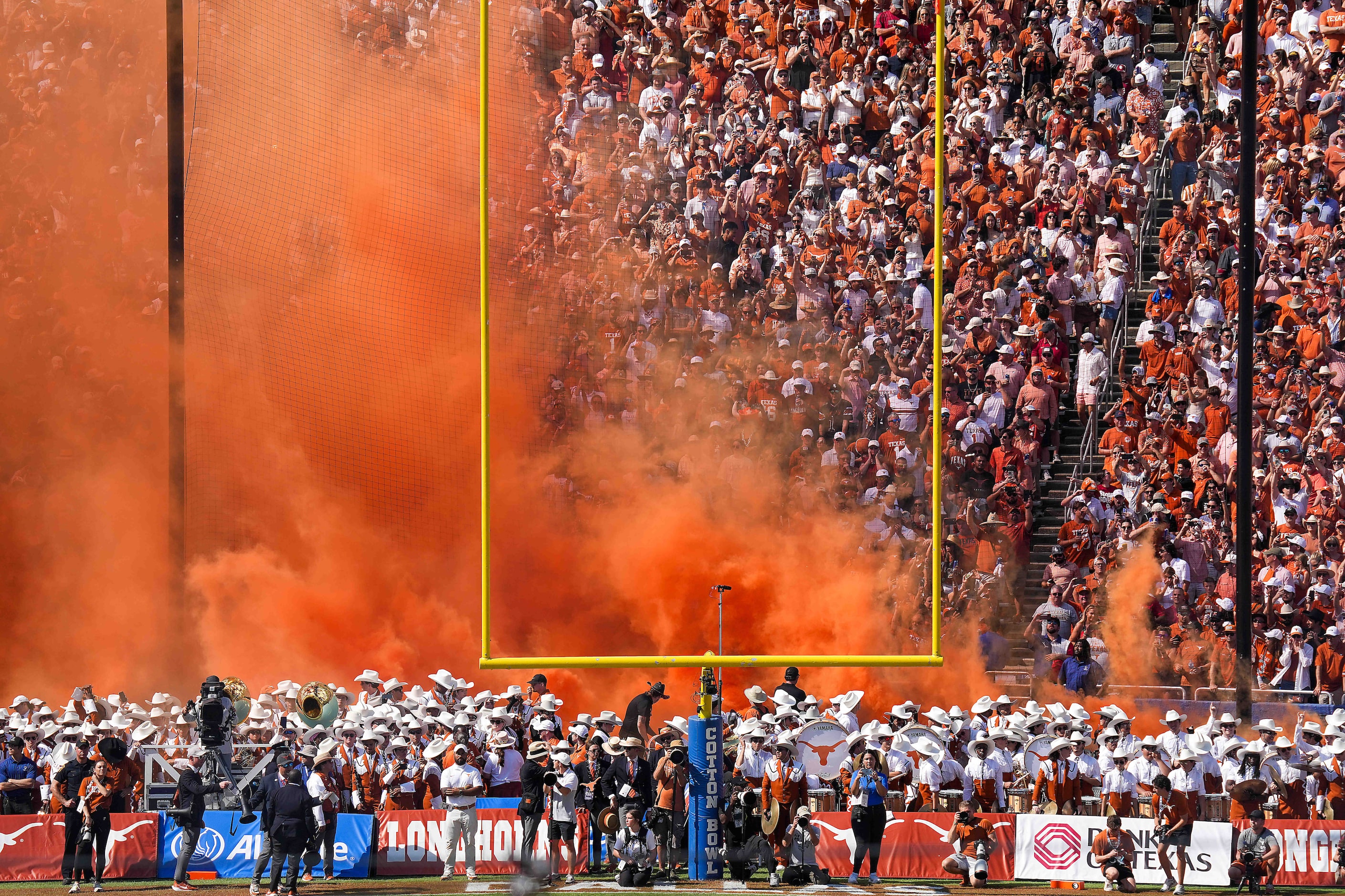 Orange smoke is released as the Texas Longhorns take the field before an NCAA college...