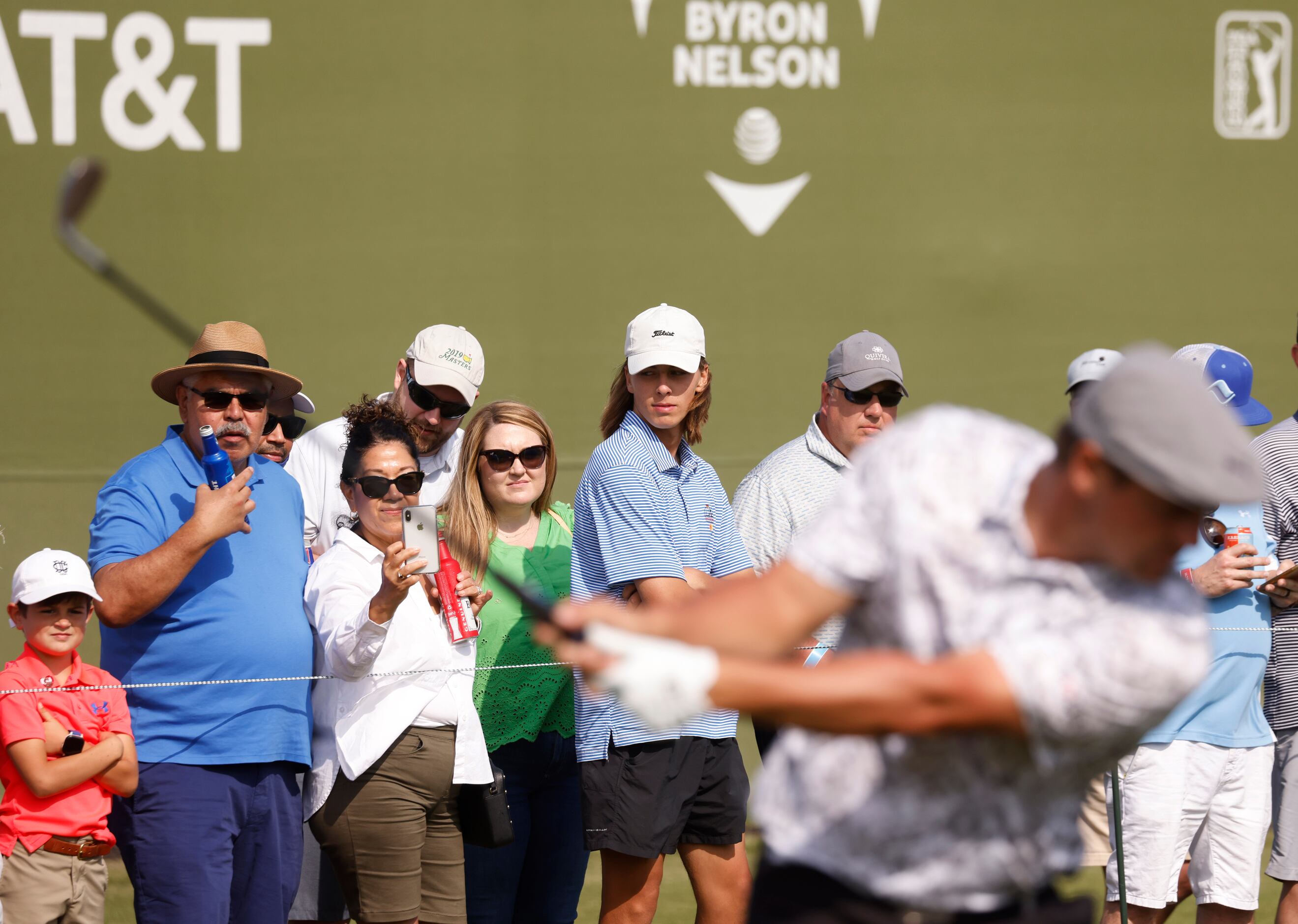 Fans watch as Bryson DeChambeau tees off on the 17th hole during round 2 of the AT&T Byron...