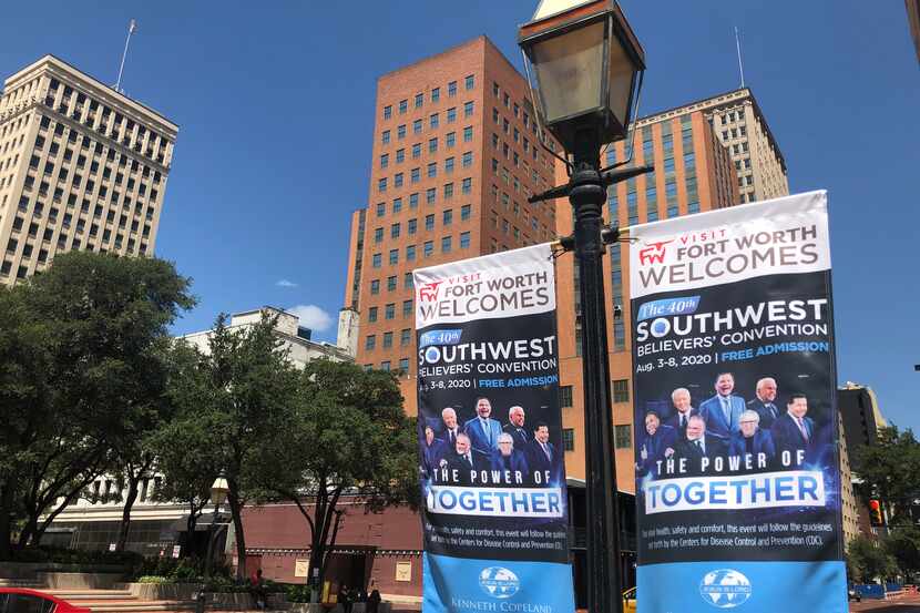 Banners for Kenneth Copeland's religious revival hang on Fort Worth streets in 2020. An...