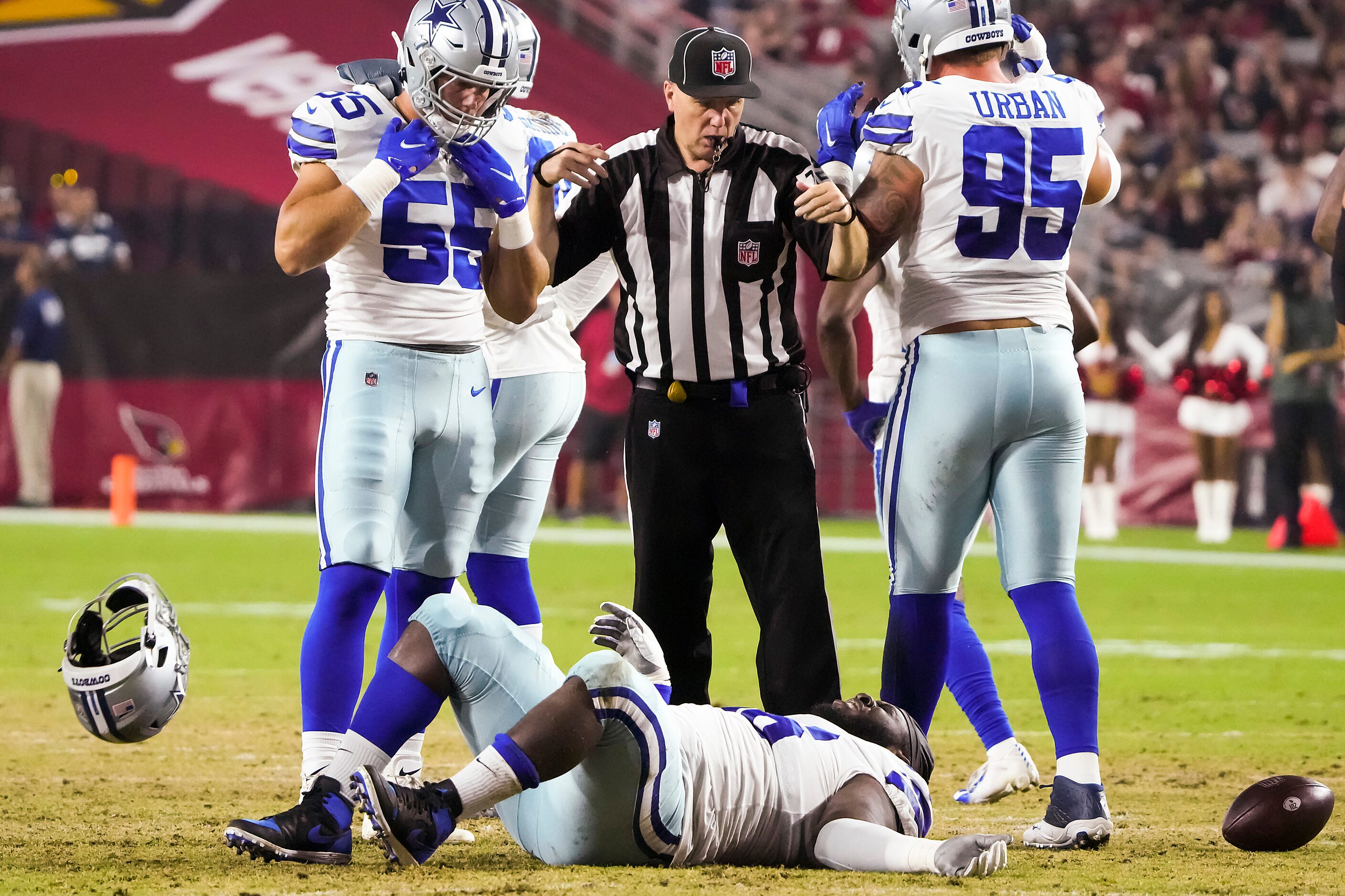 Dallas Cowboys defensive tackle Neville Gallimore (96) tosses away his helmet after being...