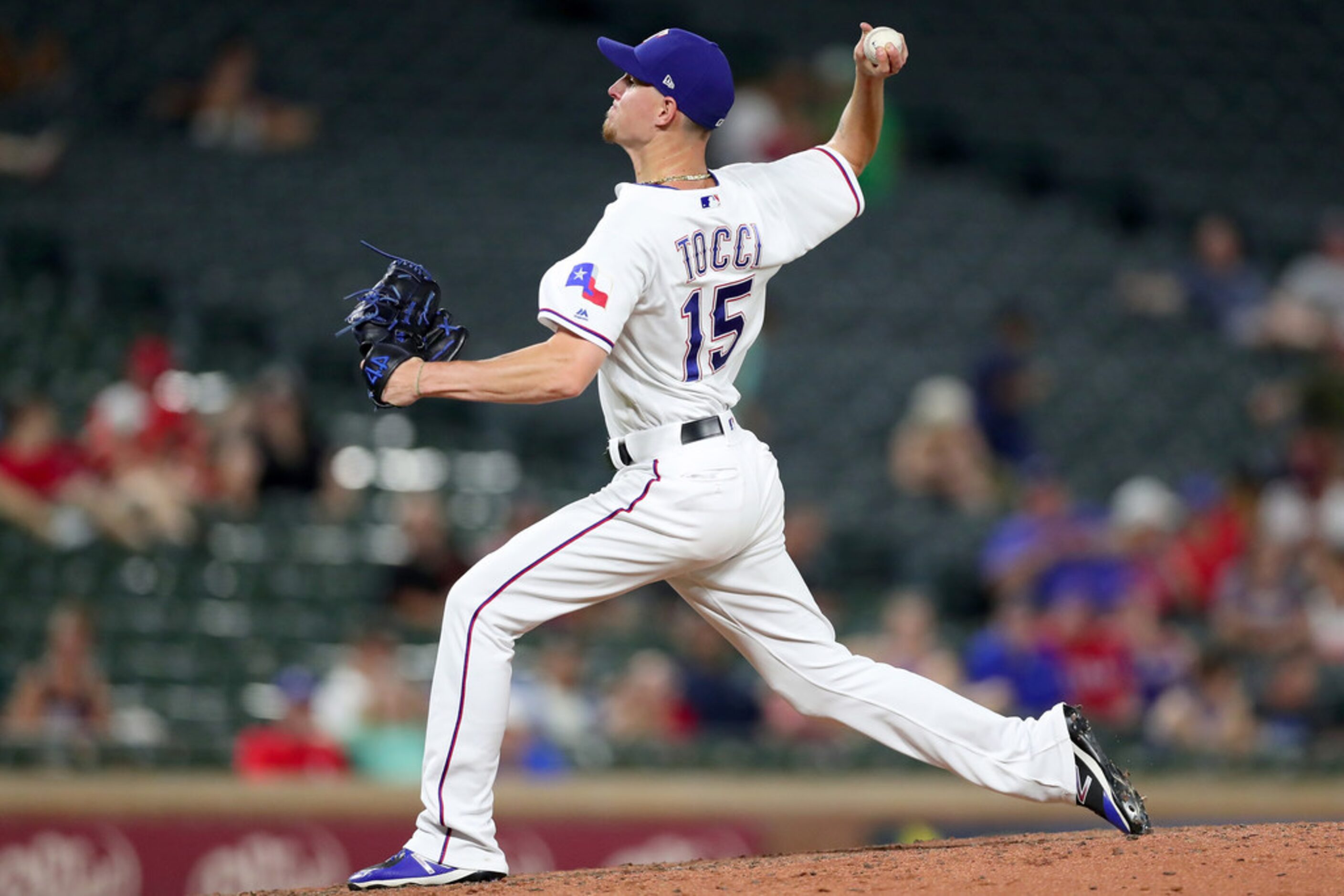 ARLINGTON, TX - JULY 23:  Carlos Tocci #15 of the Texas Rangers pitches against the Oakland...