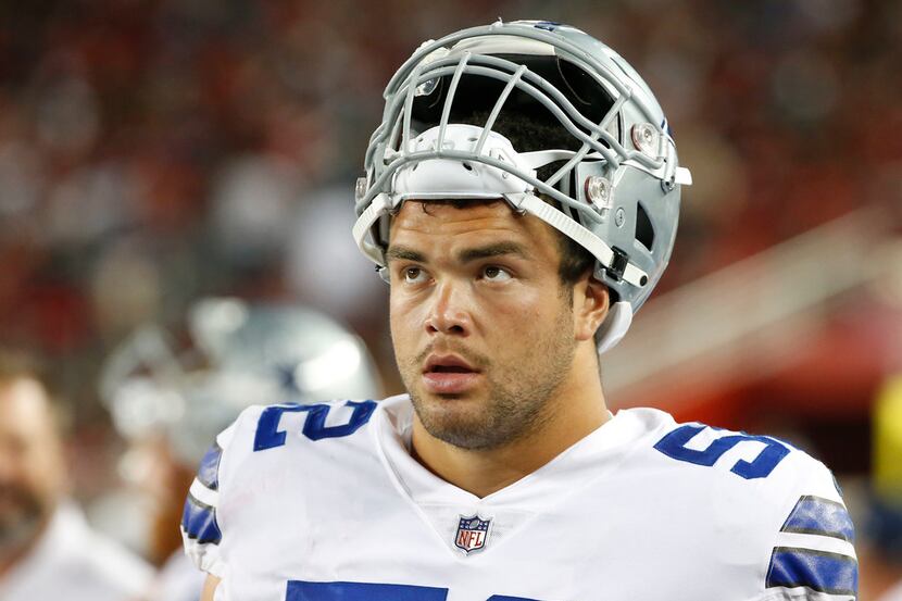 FILE - Cowboys guard Connor Williams (52) looks at a scoreboard from the bench during the...