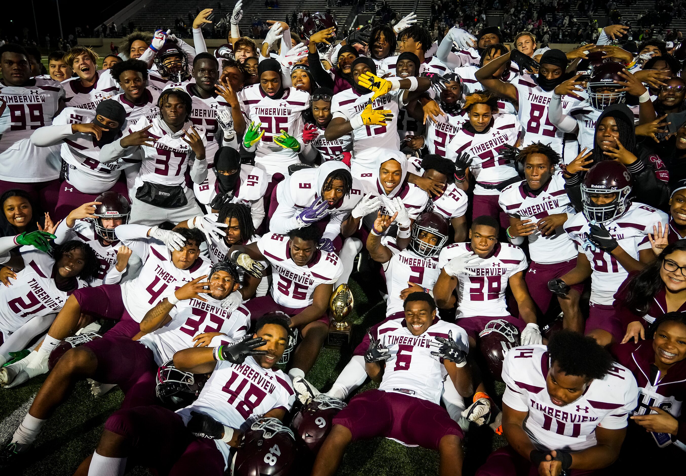 Mansfield Timberview players celebrate with a team photo after a 28-26 victory over Frisco...