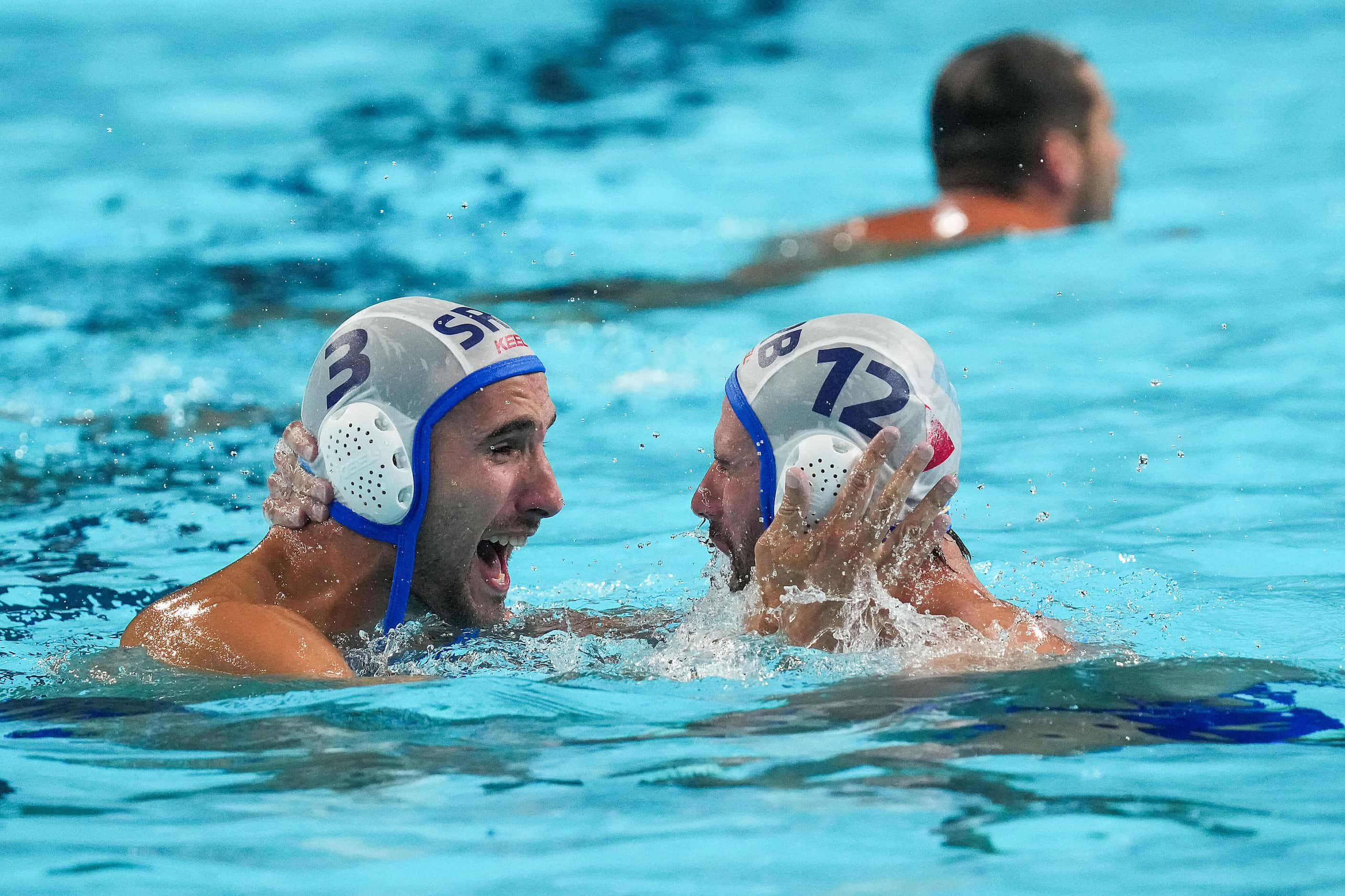 Strahinja Rasovic (3) and Viktor Rasovic (12) of Serbia celebrate after a victory over the...