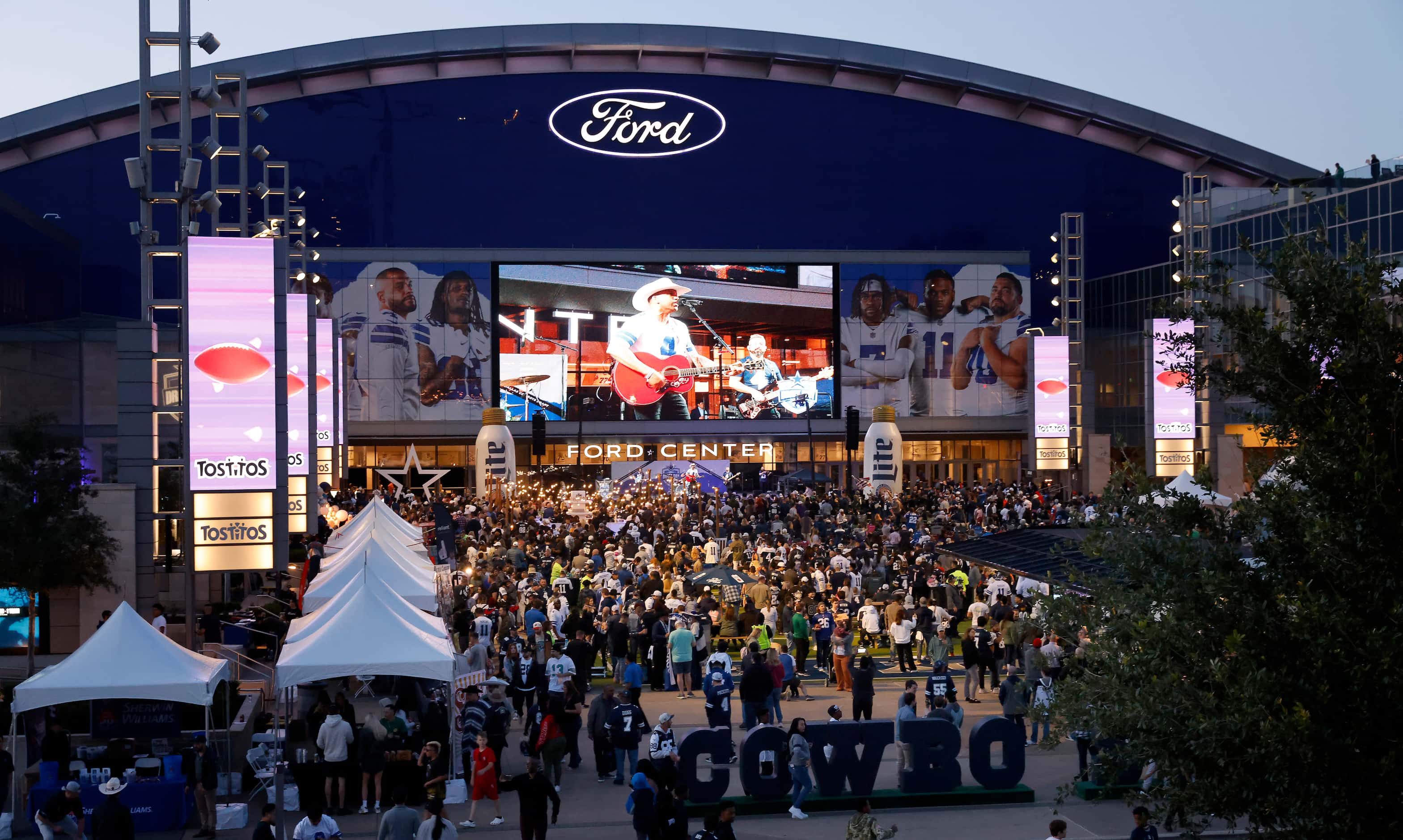 Dallas Cowboys fans gather for a draft party on the Ford Center plaza at The Star in Frisco,...