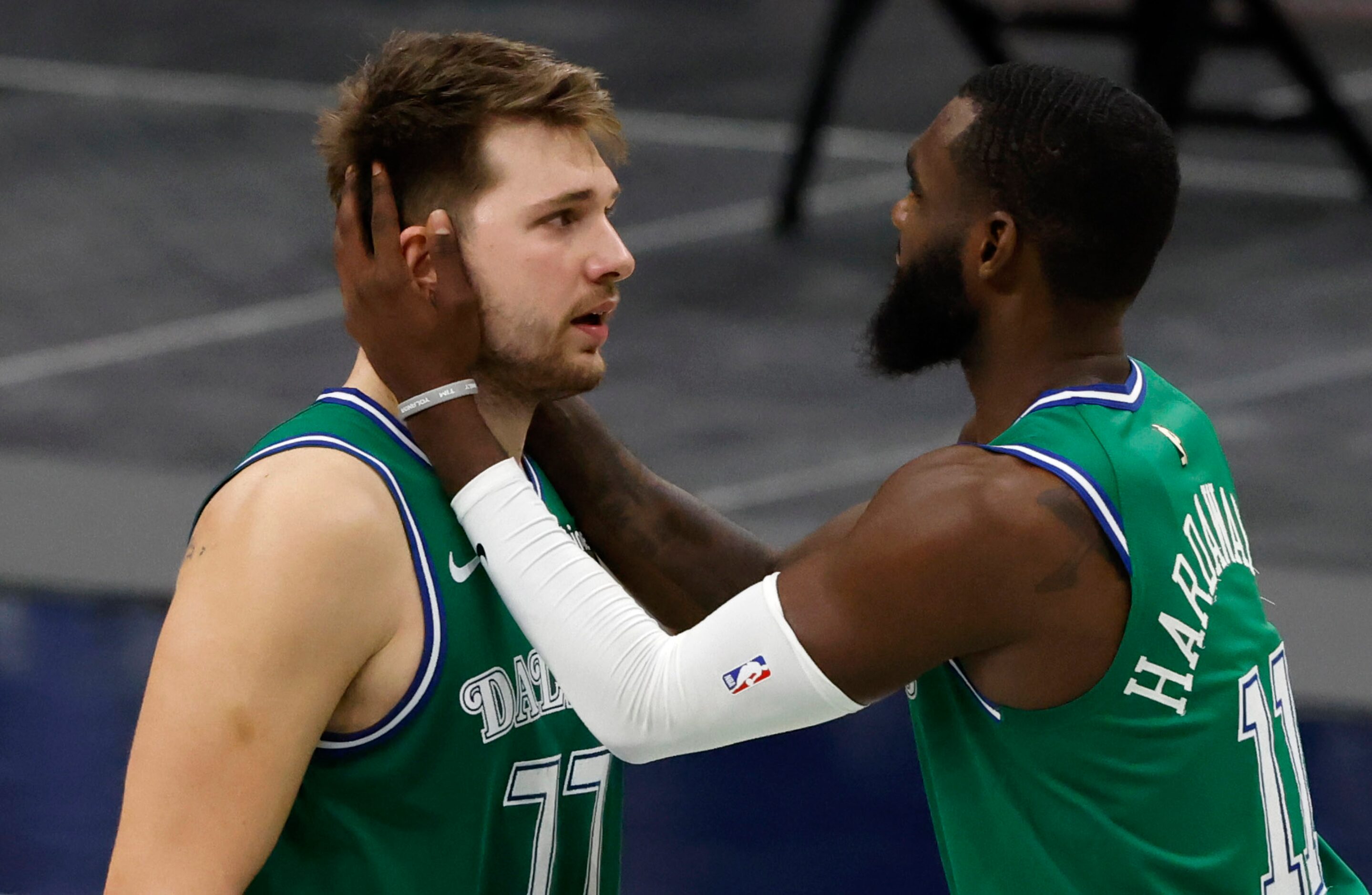 Dallas Mavericks guard Tim Hardaway Jr. (11) talks to Dallas Mavericks guard Luka Doncic...