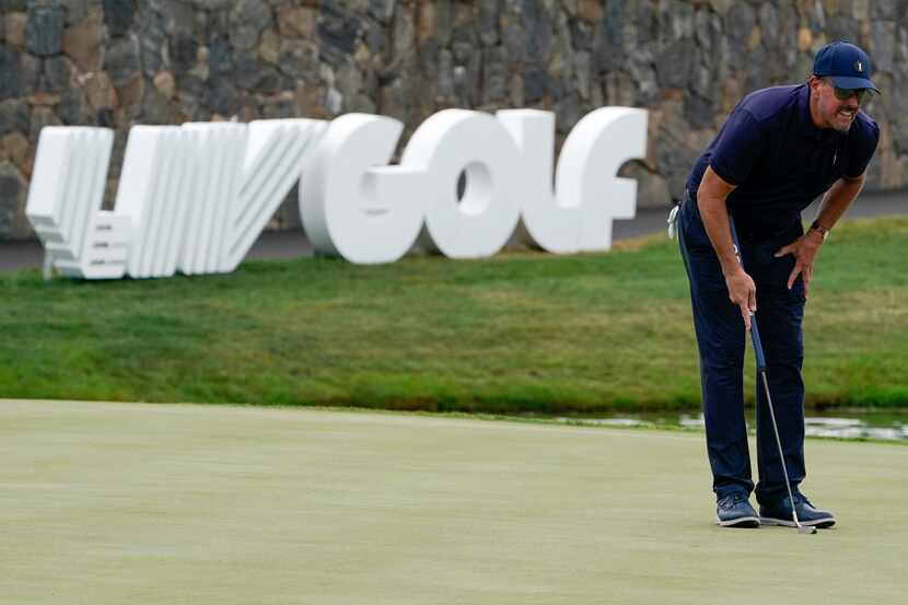 Phil Mickelson lines up a shot on the 18th hole during the first round of the Bedminster...