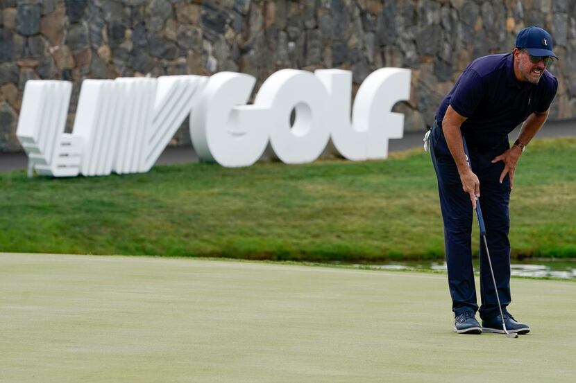 Phil Mickelson lines up a shot on the 18th hole during the first round of the Bedminster...