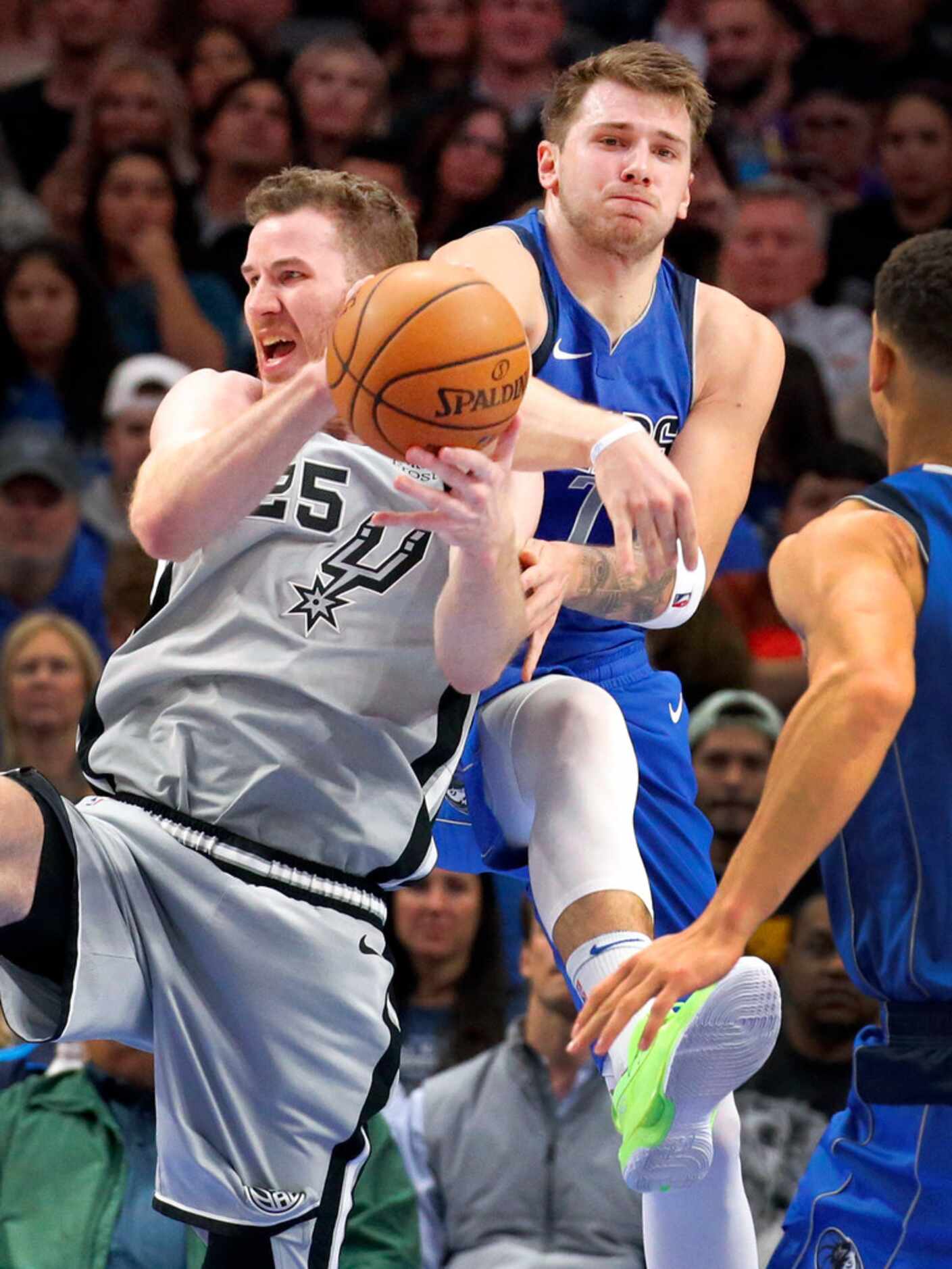 Dallas Mavericks forward Luka Doncic (77) fights for control of the ball with San Antonio...