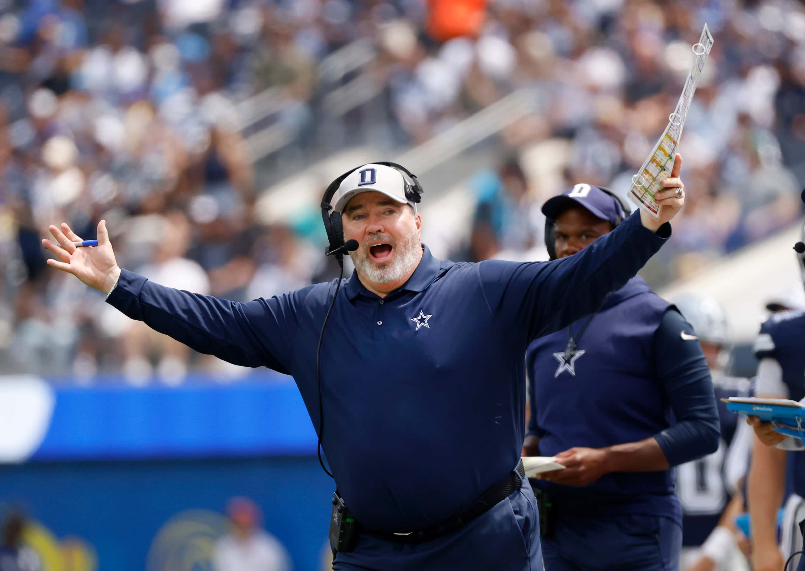 Dallas Cowboys head coach Mike McCarthy yells toward an official before a play starts...