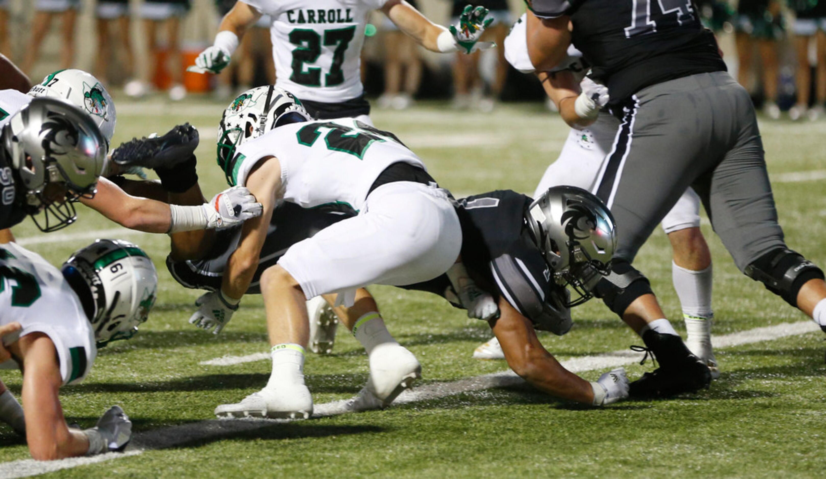 Denton Guyer's Kaedric Cobb (1) dives for a touchdown as Southlake Carroll's Josh Sweat (24)...