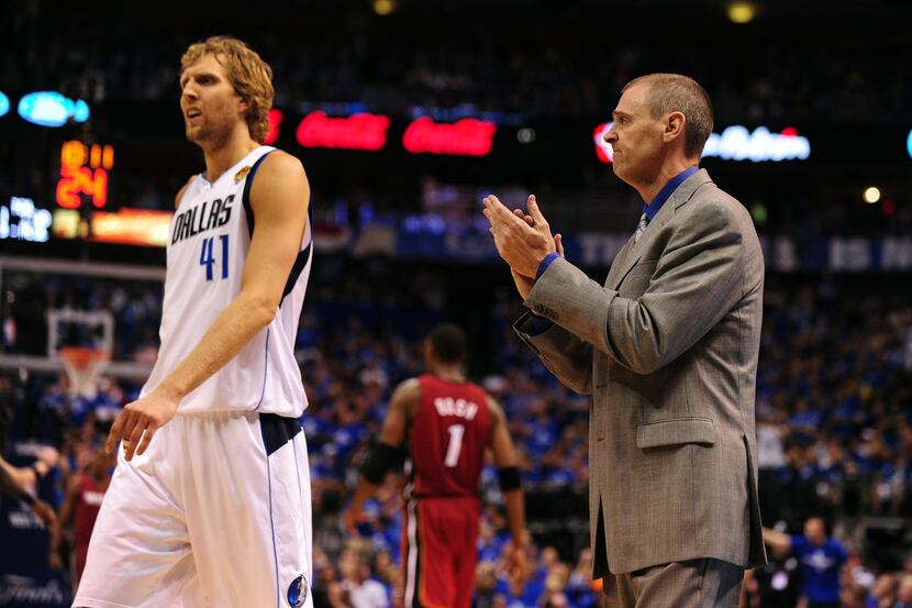 Dallas Mavericks head coach Rick Carlisle applauds while Dirk Nowitzki (L) walks off the...