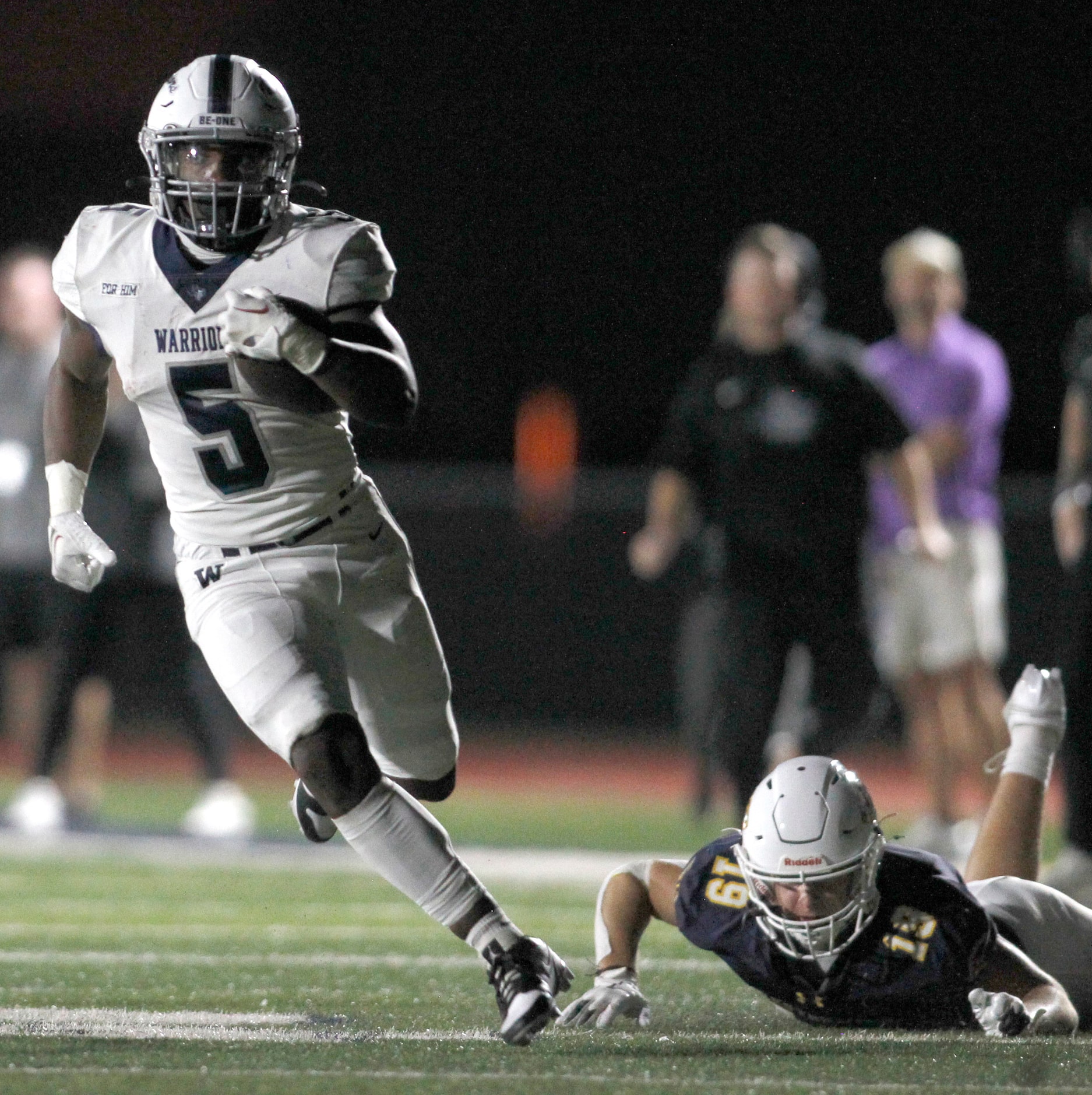 Argyle Liberty Christian running back Chase Garnett (5), left, eludes the attempted tackle...