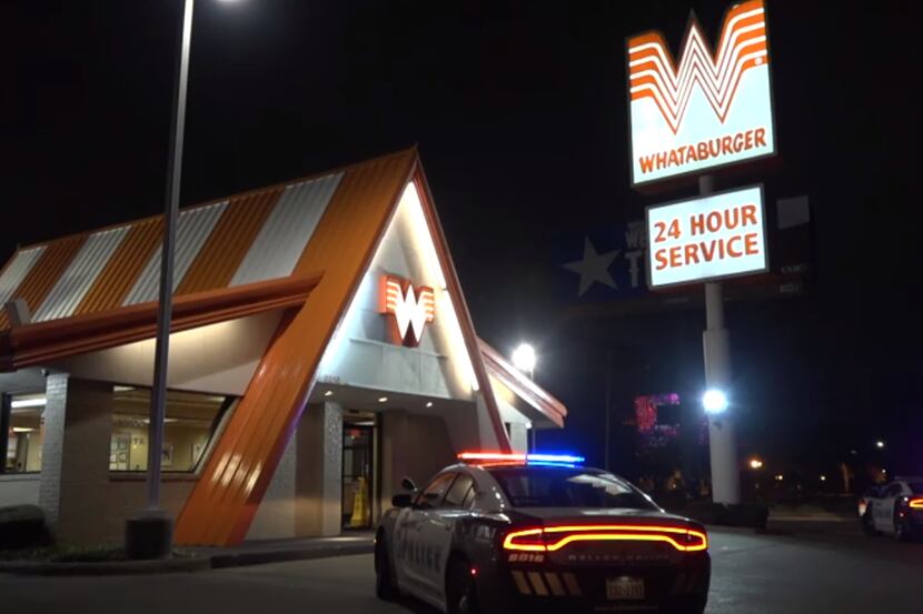 Dallas police cars at the scene of a robbery at the Whataburger on Stemmons Freeway near...