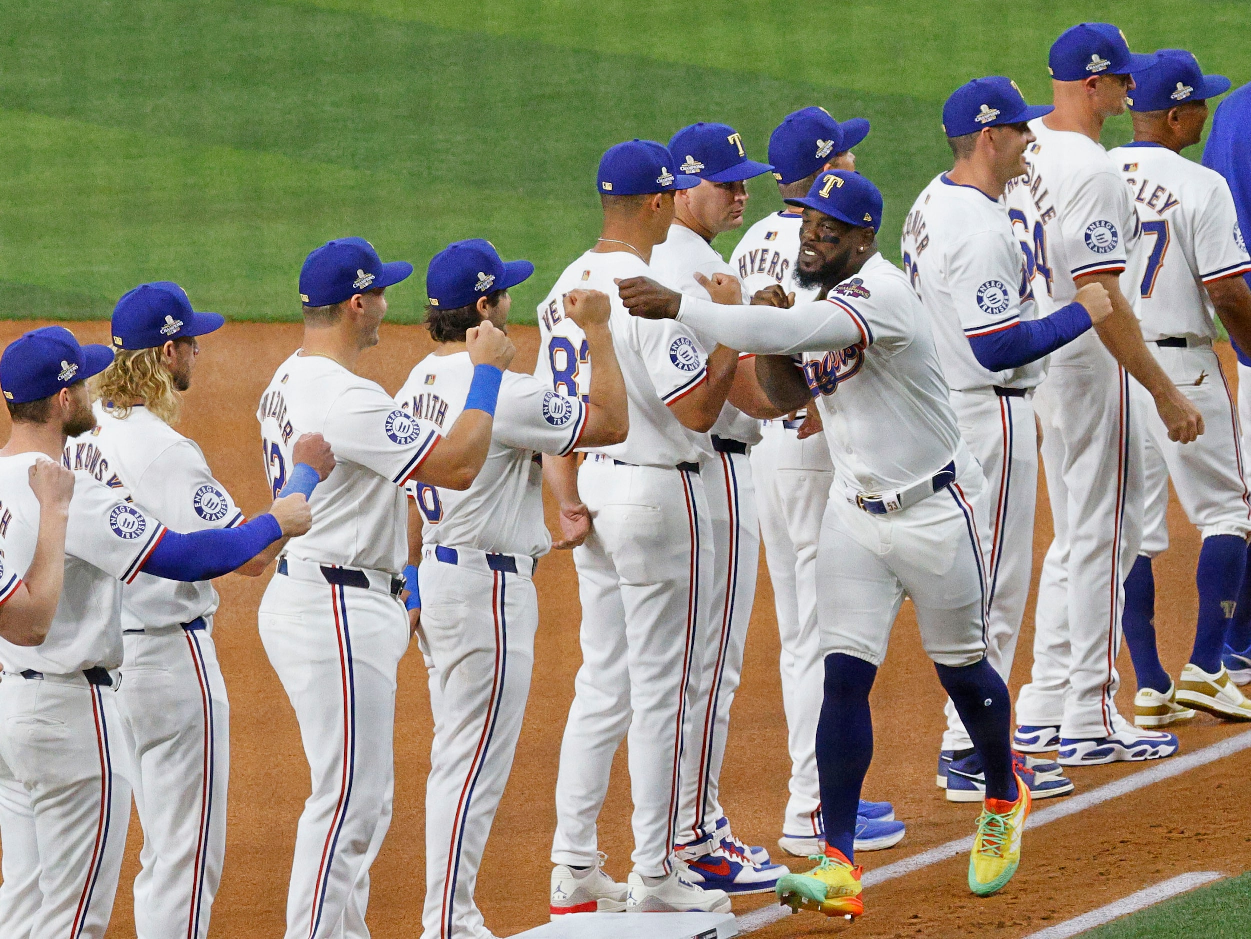 Texas Rangers right fielder Adolis Garcia (53) receives high fives from his teammates during...