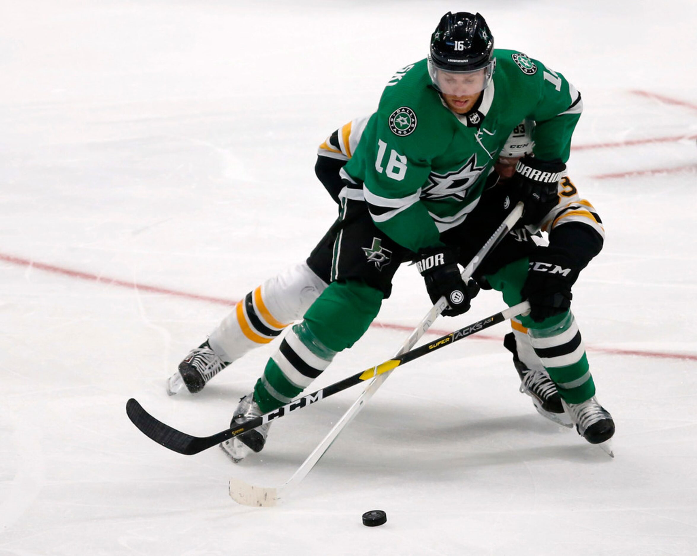 Dallas Stars center Jason Dickinson (18) attempts to pass as Boston Bruins center Karson...