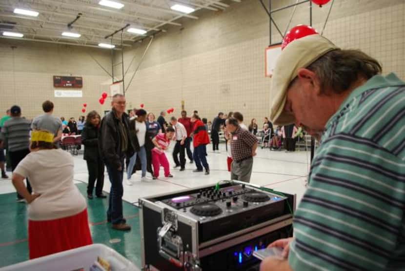 
Little Elm resident Shane Manning deejays for the dance party in the gymnasium at Memorial...