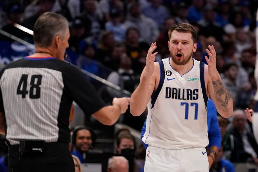 Dallas Mavericks guard Luka Doncic (77) questions a call by referee Scott Foster (48) during...