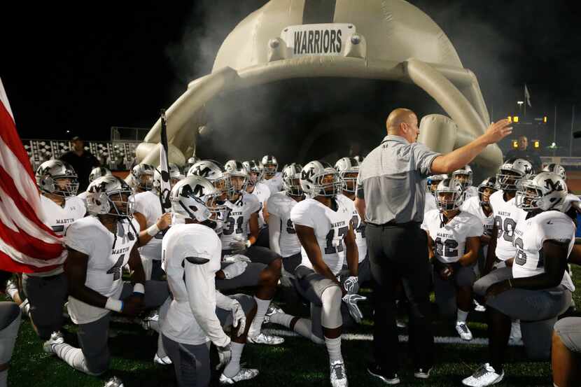 Arlington Martin head coach Bob Wager rallies his team prior to their high school football...