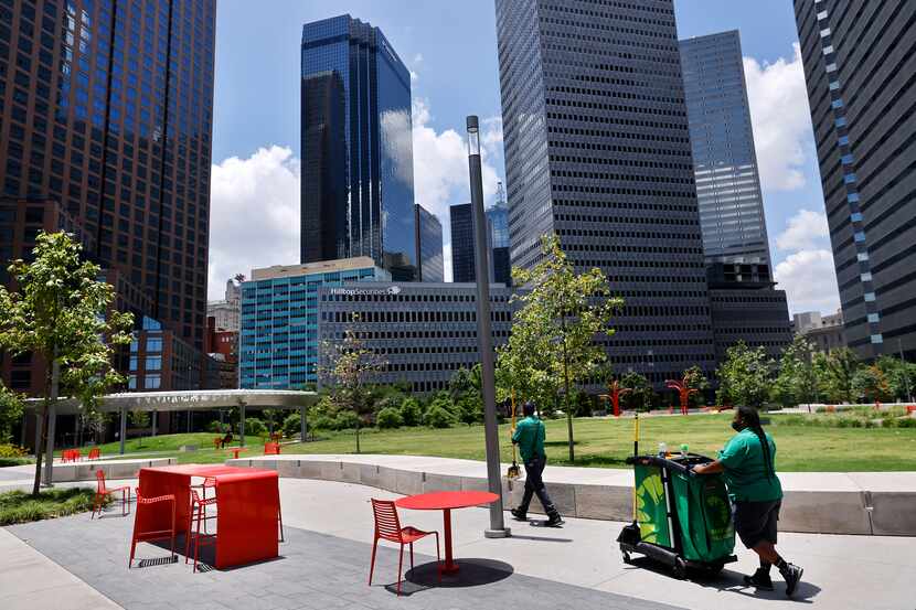 Downtown Dallas Inc. clean-team members work Wednesday in Pacific Plaza.