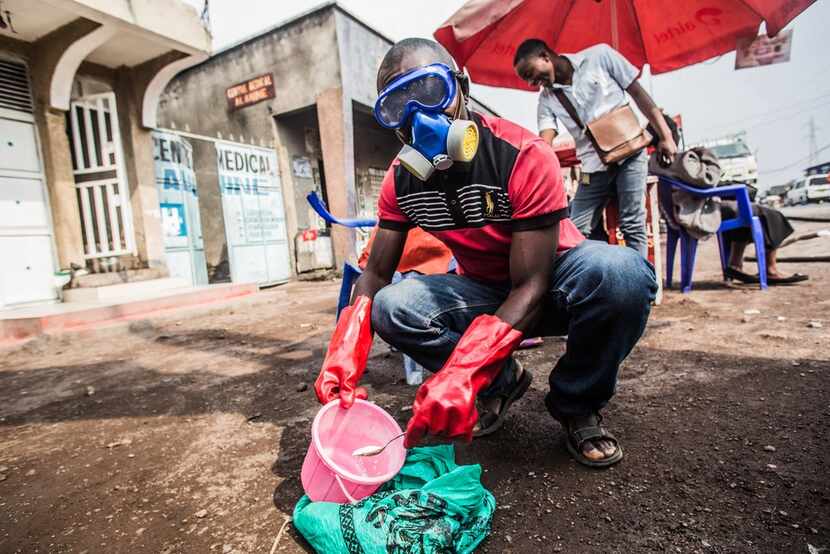A health worker wearing protective gear mixed water and chlorine in Goma, Congo, in July. 