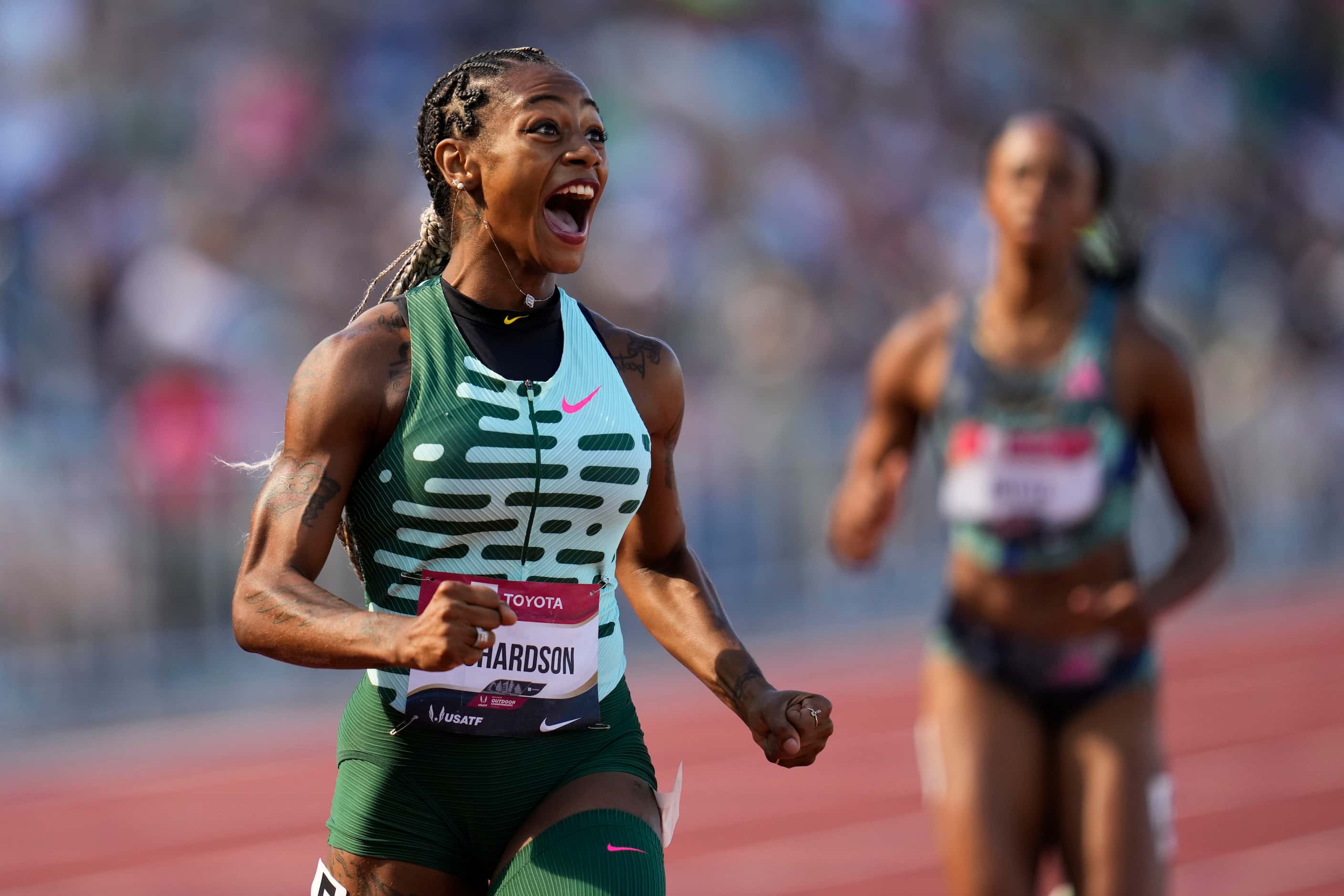 Sha'Carri Richardson reacts as she wins her heat in the first round of the women's 200...