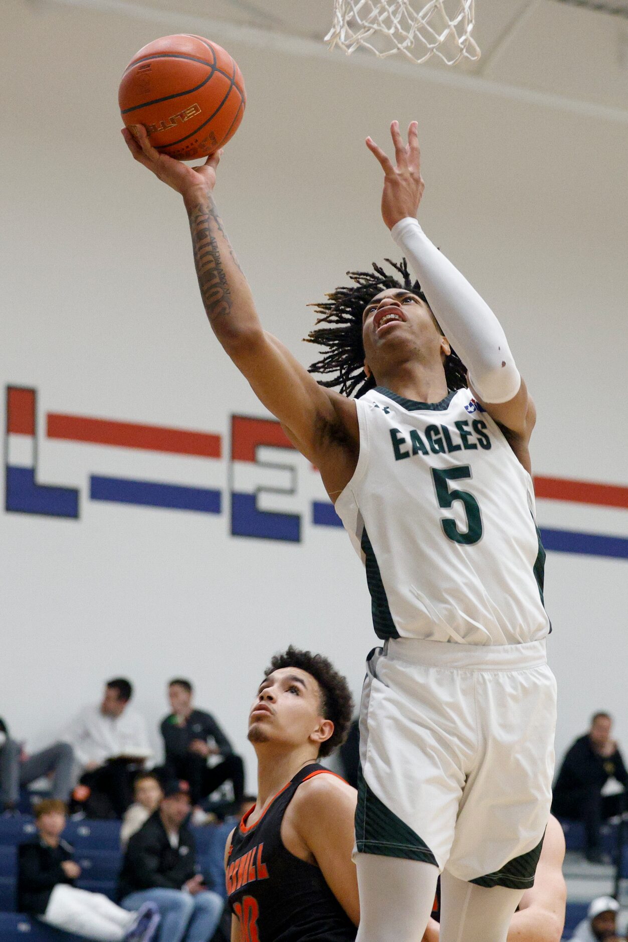 Mansfield Lake Ridge's Ahmare Rose (5) lays the ball up during the second half of a...