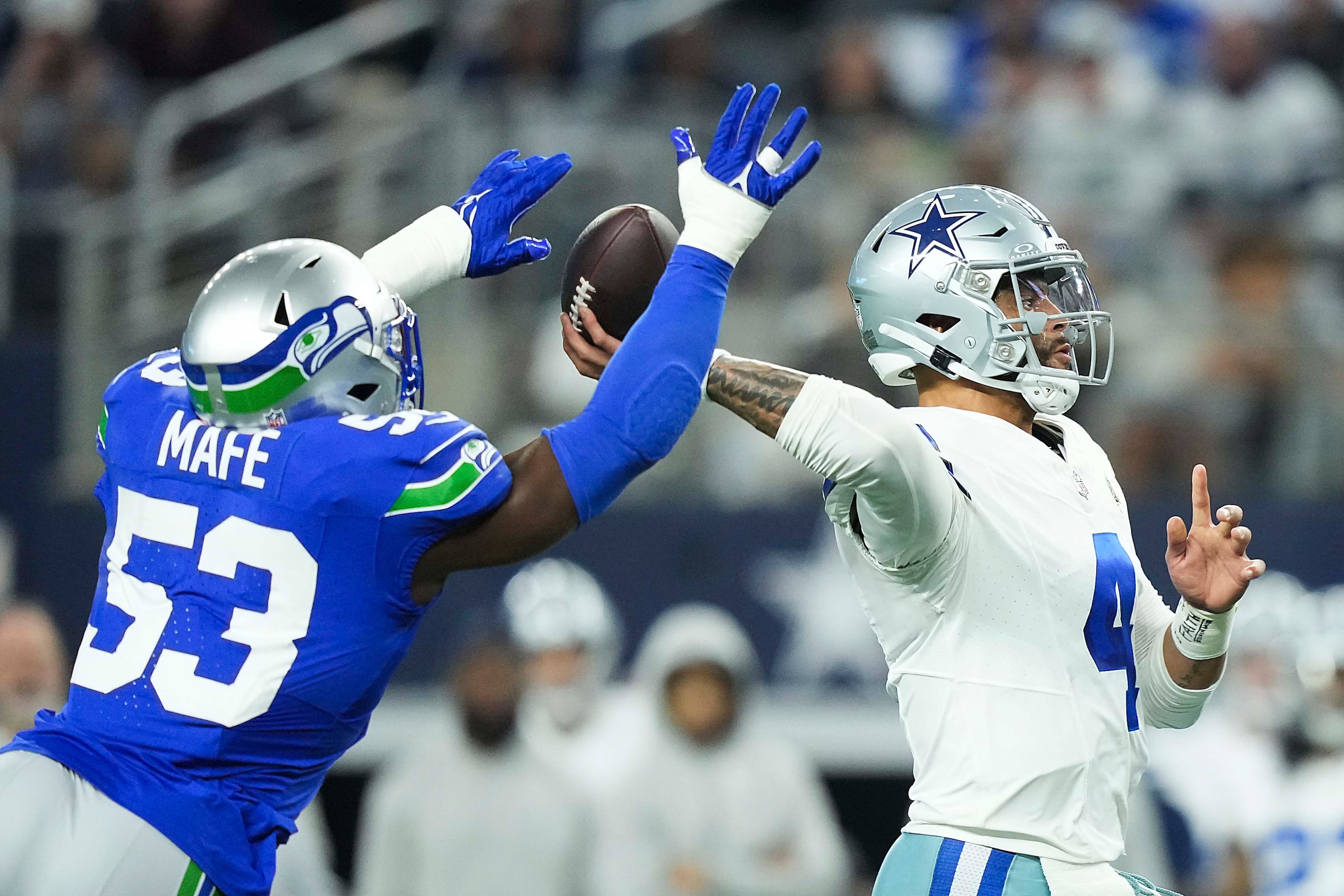 Dallas Cowboys quarterback Dak Prescott (4) throws a pass under pressure from Seattle...