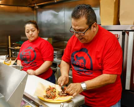 Owner Jesus Carbona (right) prepares asada tacos campion alongside chef Nelly Ramos at...