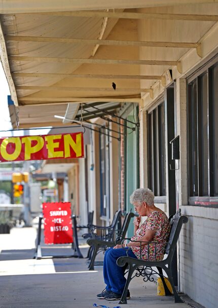 Resident Mary Beyer takes a smoke break in downtown Rockdale, Texas, Thursday, June 14, 2018. 