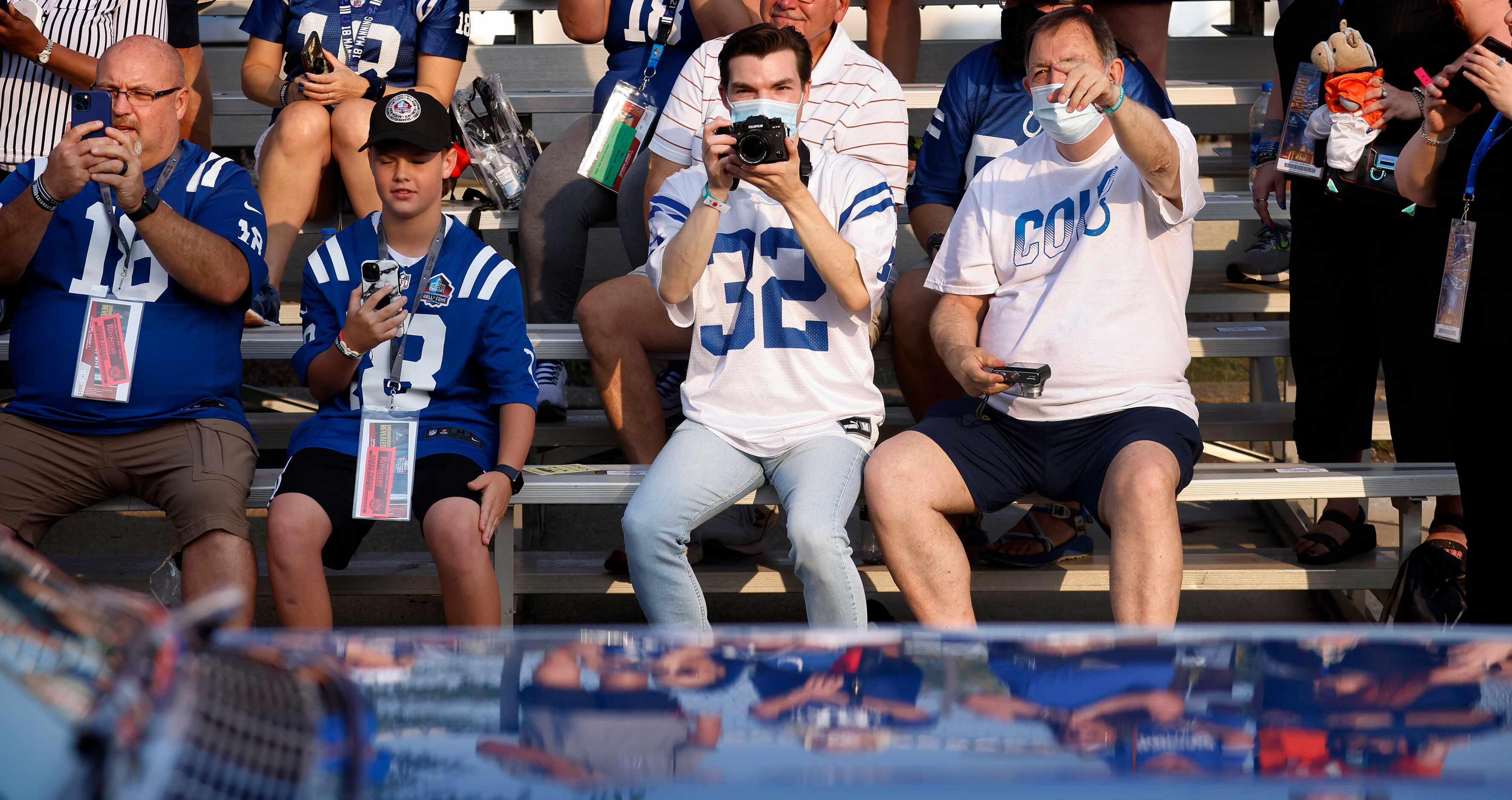 Indianapolis Colts fans photograph a Pro Football Hall of Fame member who passes in the...