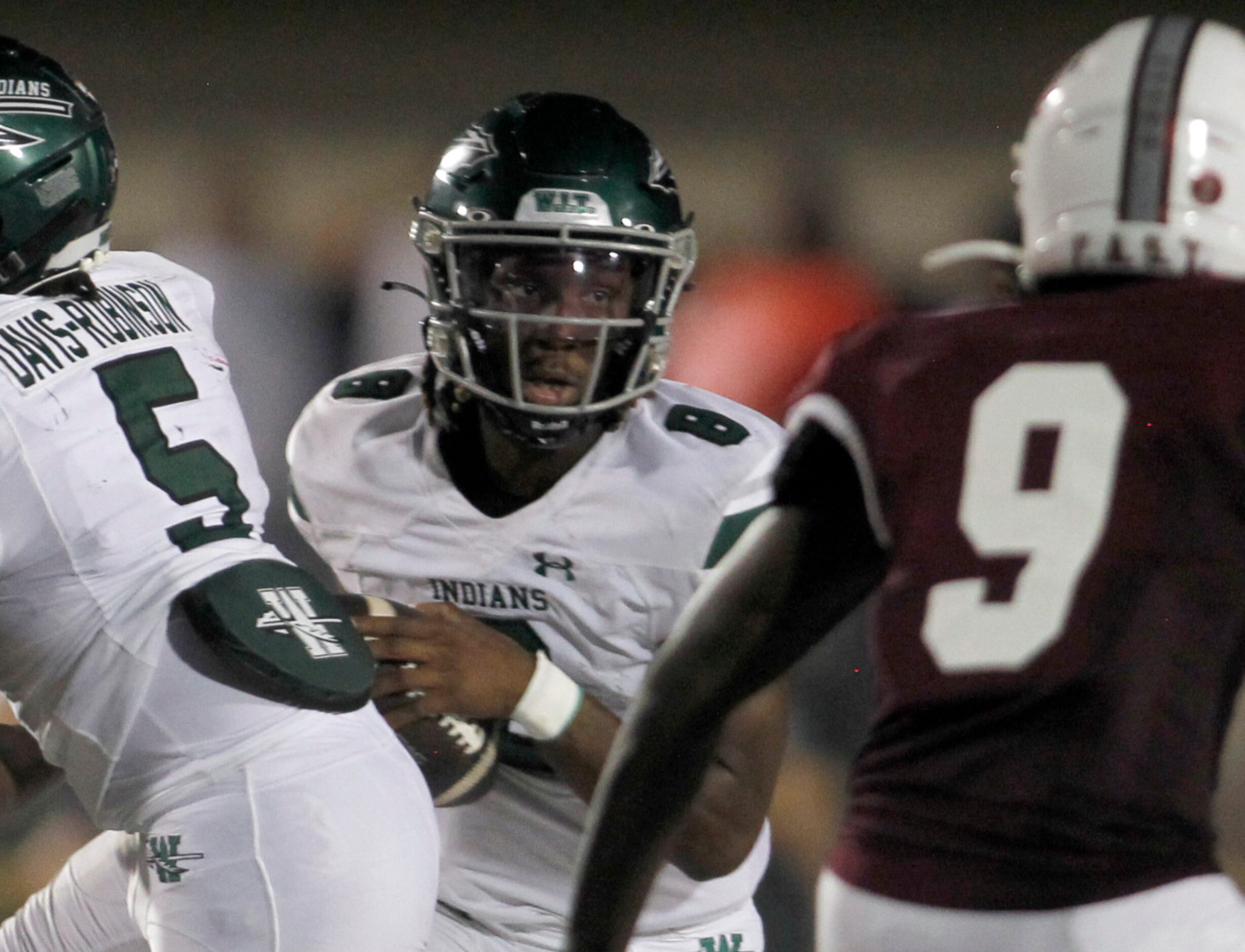 Waxahachie quarterback Ramon McKinney Jr. (8) looks for a running lane after taking a snap...