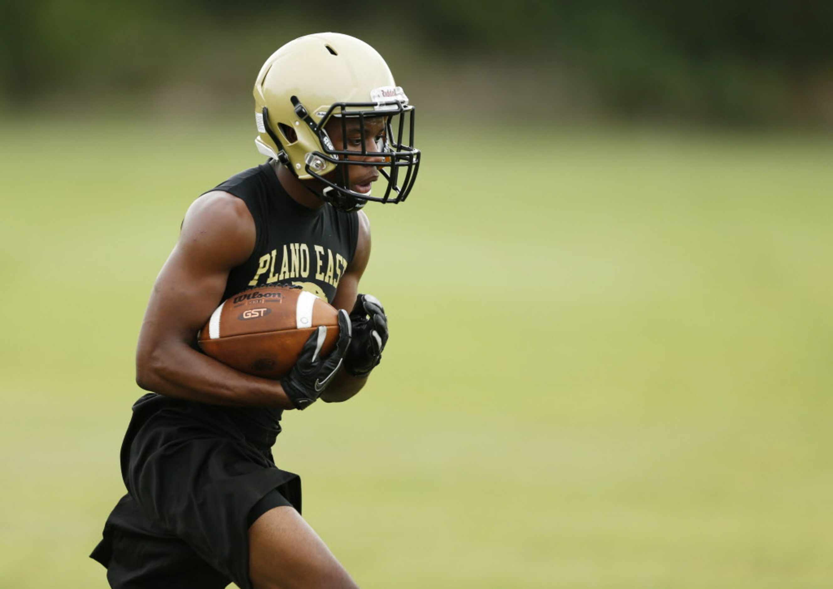 Plano East's running back Jaquawan Douglas rushes the ball up the field on a play during the...