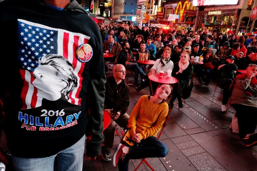 People gather around Times Square to watch televised results of the US presidential election...